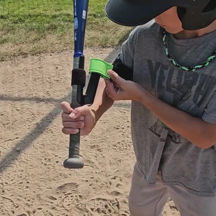 boy baseball and girl softball players training with swingrail swing trainer